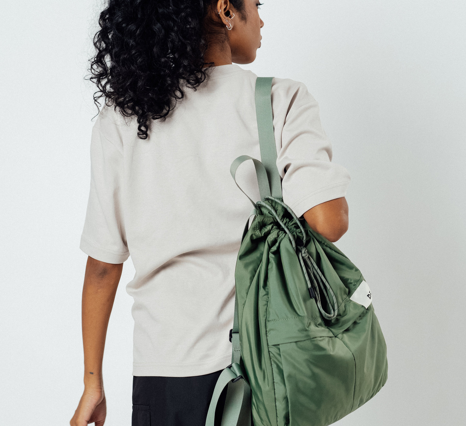 Way Backpack with camera, charger, and notebook, perfect for the on-the-go festival creator.